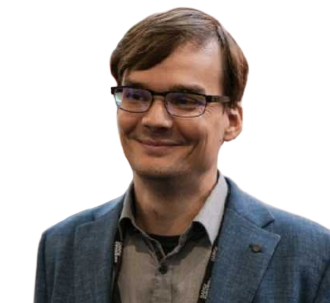 Man with glasses and a blue blazer smiling.
