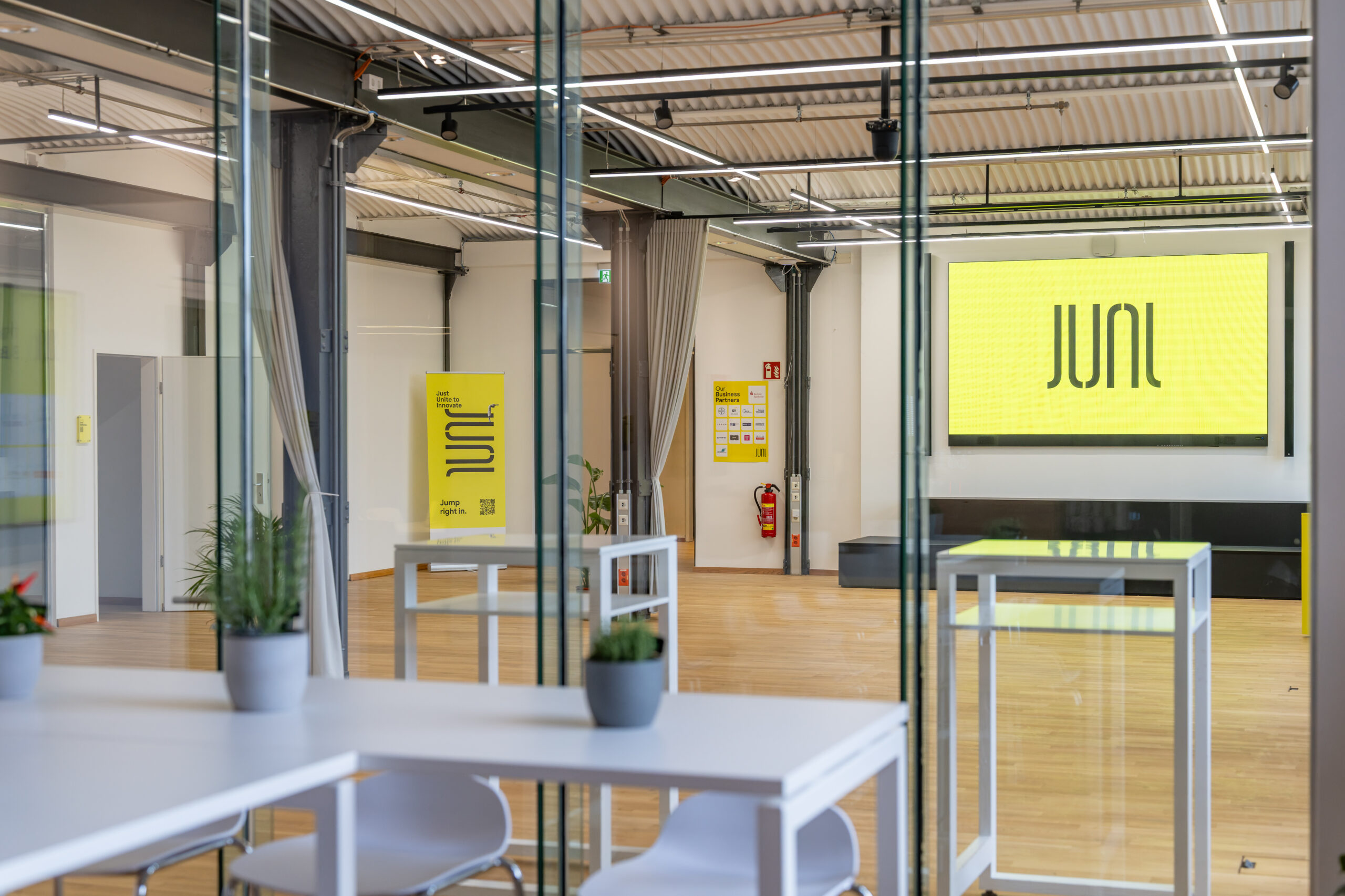 Modern workspace featuring JUNI branding and industrial design elements.