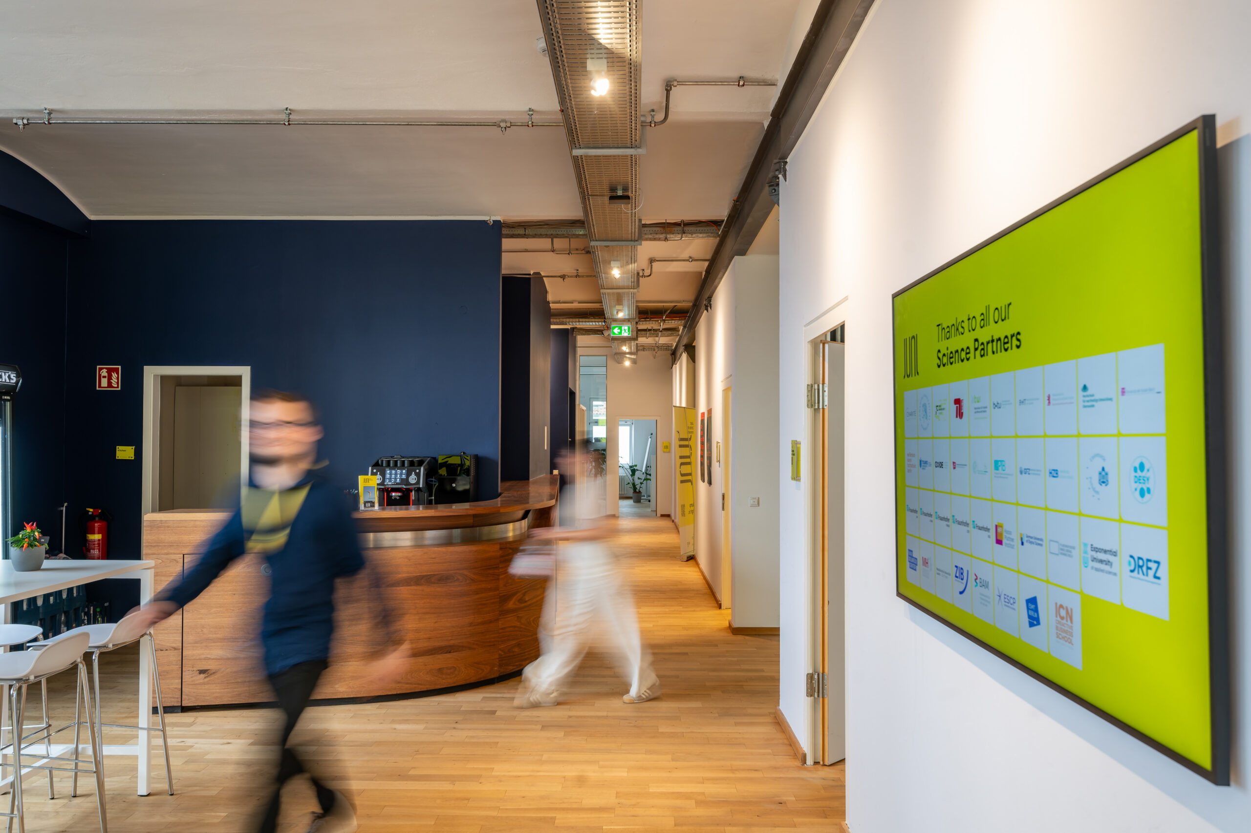 Modern office interior with reception desk and partner board.